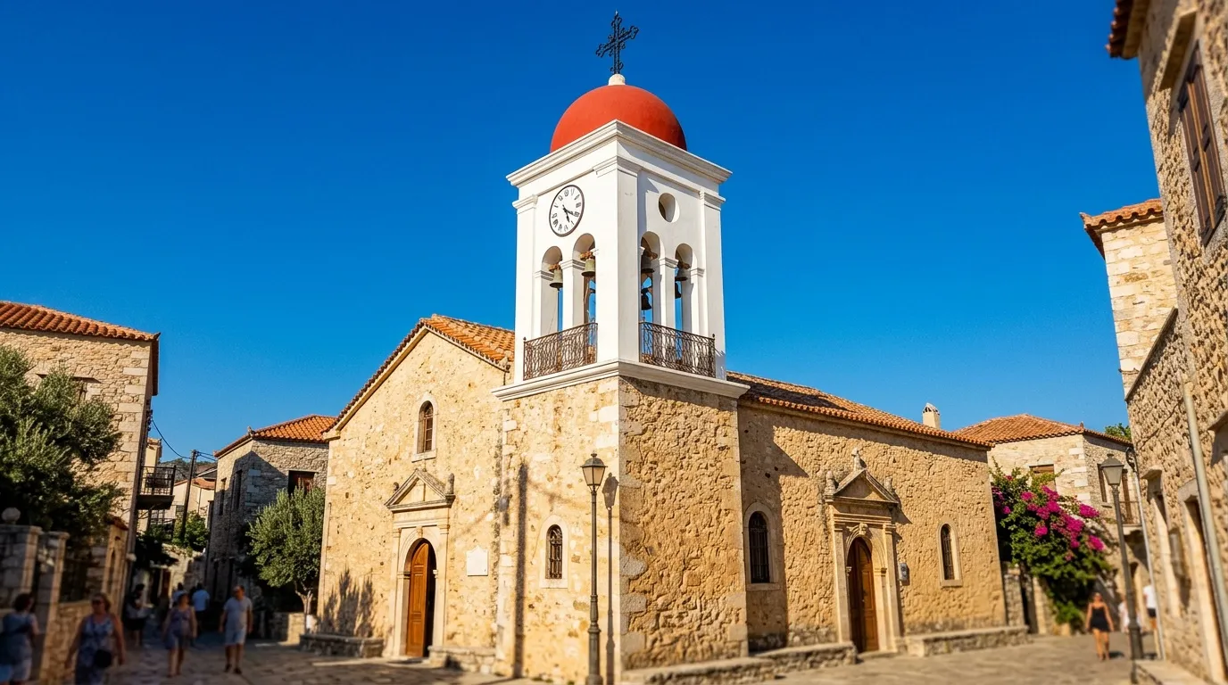 Église en pierre avec dôme rouge et clocher blanc, village côtier